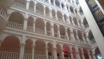 A multi-level building with balconies and arched windows.