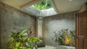 A room with a skylight, a column, and potted plants. - Large Groups,9 BDR,Close To Beach,Great Inclusions (Canggu)