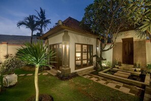 Stylish home with a traditional and modern blend, surrounded by a lush garden and an entrance.