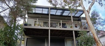 Holiday house nestled among native trees overlooking wetlands