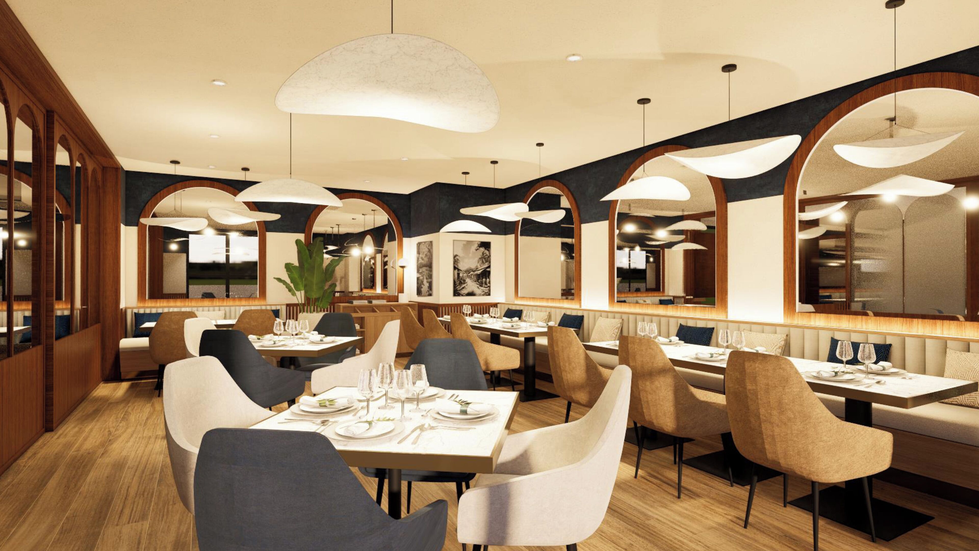 Un interior de restaurante moderno con techos altos, ventanas arqueadas y lámparas de diseño contemporáneo.