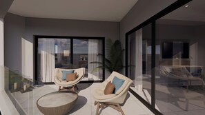 A modern living room with two armchairs, a round coffee table, and a large glass door leading to a balcony.