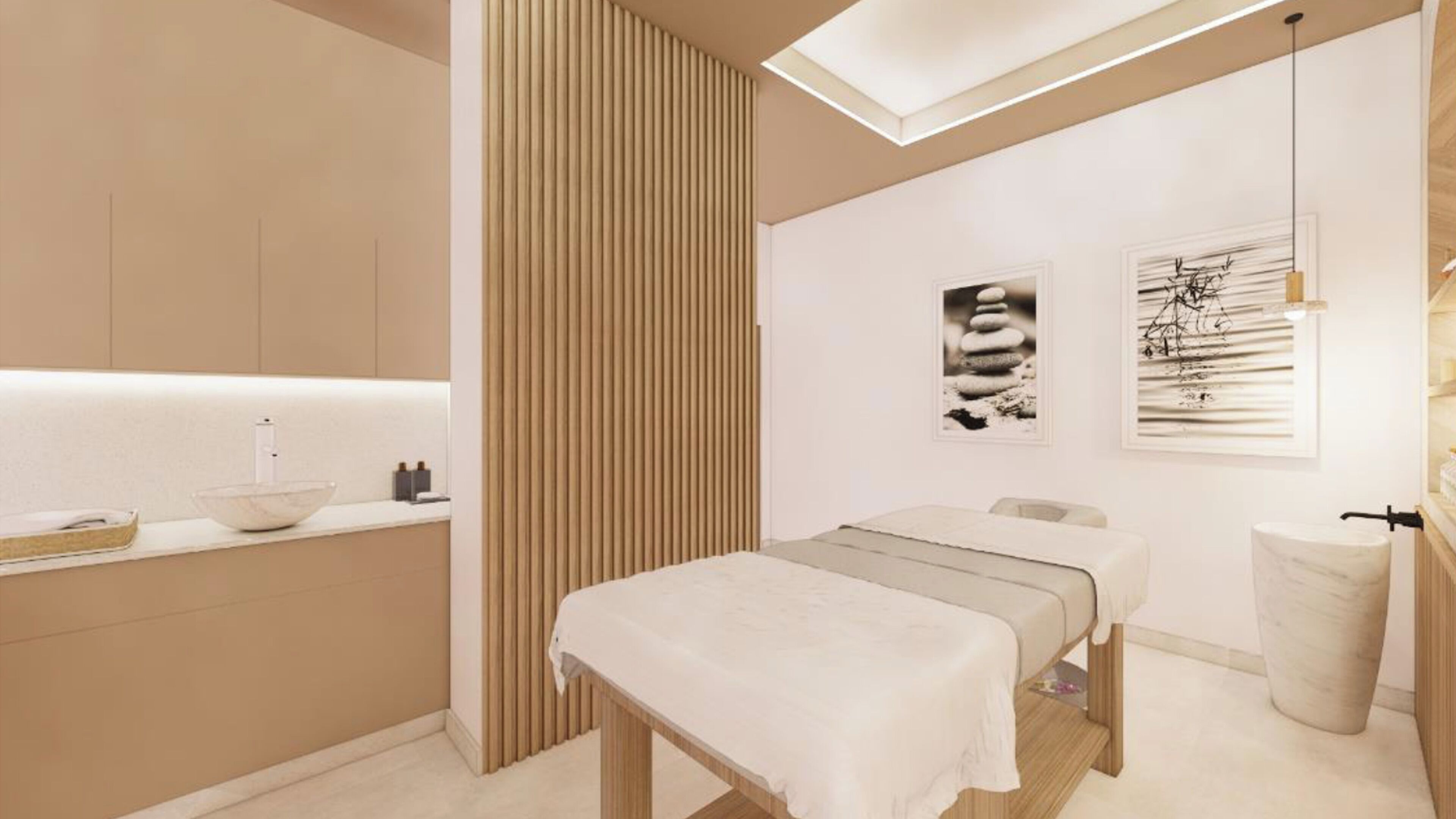 A modern spa room with a large window, a reception desk, a massage table, and a small sink.