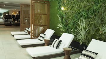 Relax in a serene space with lounge chairs and lush greenery.