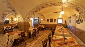 A restaurant with long communal tables, individual booths, and a tiled floor. - Gasthof-Pension Kerber (Fürstenstein)
