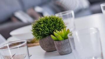 A table with a potted plant and a glass of water.