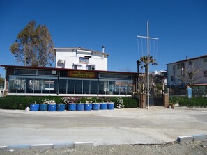 A building with a sign reading "Sandal Restaurant Cafe & Bar".