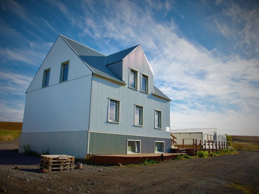 A two-story building with a gabled roof and multiple windows.