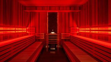 A sauna with wooden benches and a central bench.