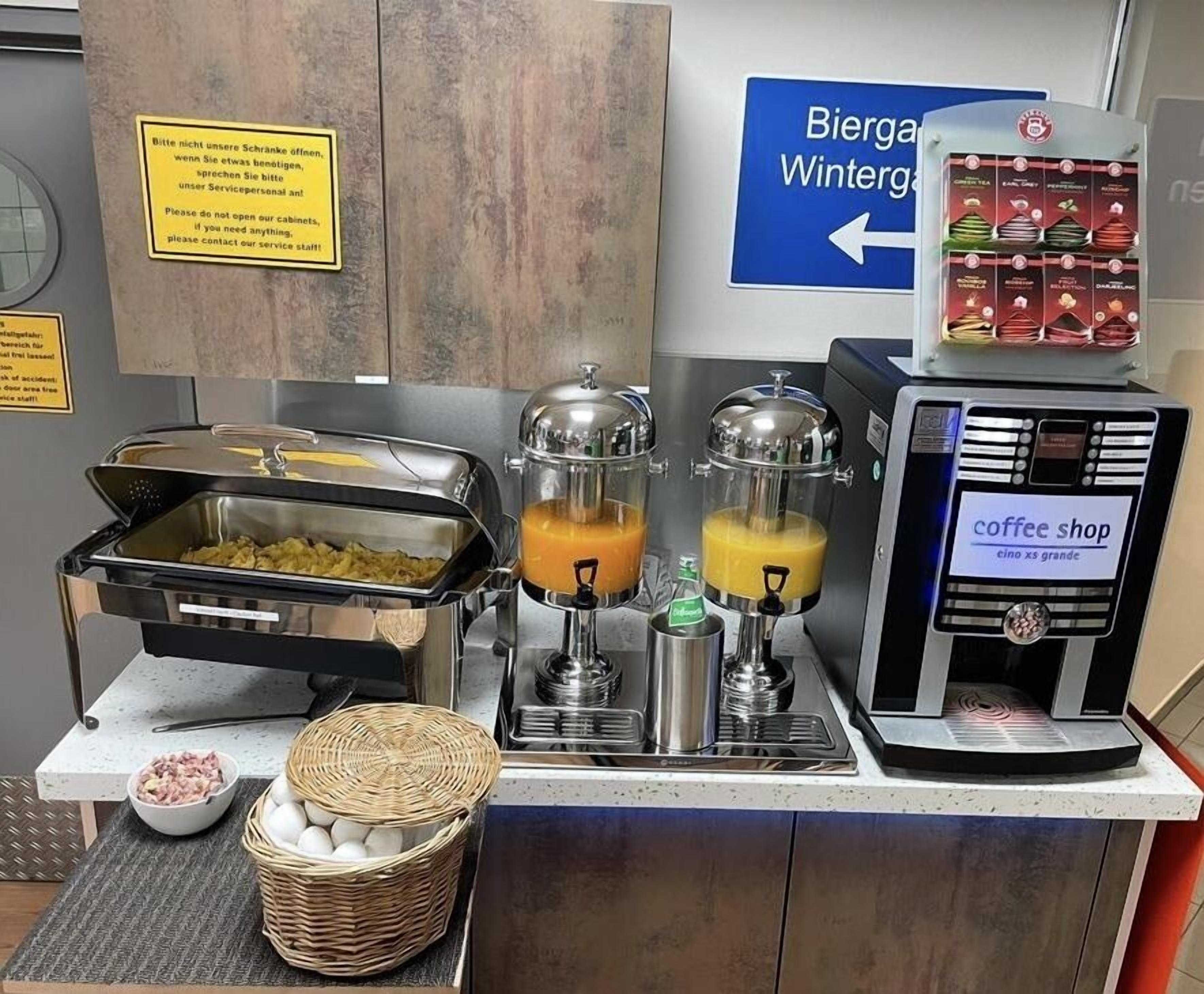 A buffet area with food stations, a coffee shop, and a sign for Biergarten Wintergarten.