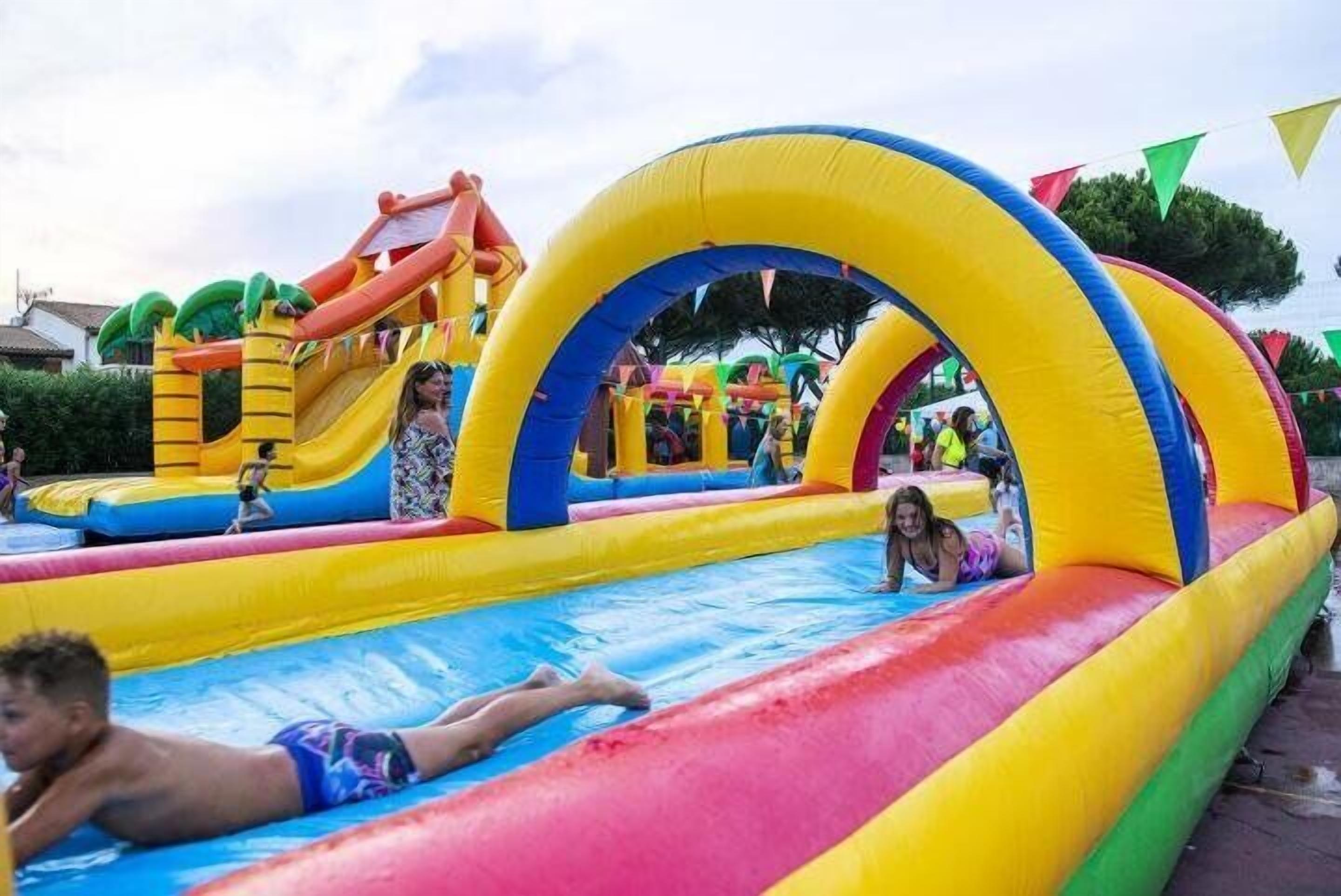 An inflatable water park with slides and a climbing structure.