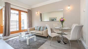 Apartment, 1 Bedroom | Living area | 55-inch flat-screen TV with cable channels, TV