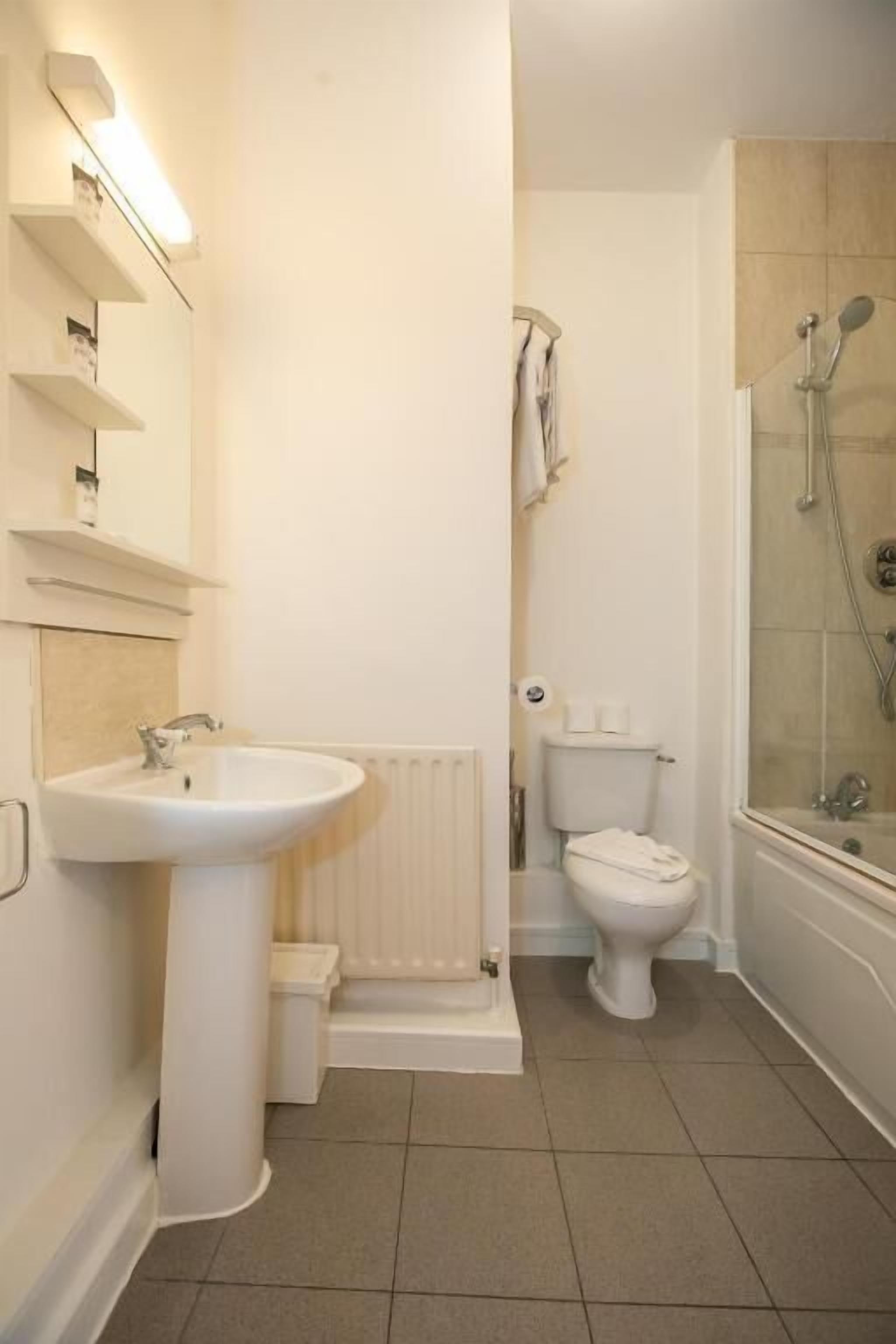 Ein Badezimmer mit Waschbecken, Toilette und Dusche.