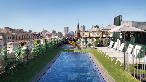 A rooftop pool with lounge chairs and a cityscape view. - Occidental Diagonal 414 (Barcelona)