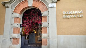 A building entrance with an ornate archway, a sign reading "Carrer Del Bruc", and a sign for "Occidental Diagonal 414". - Occidental Diagonal 414 (Barcelona)
