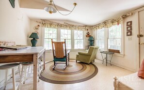 Relax in this inviting room with a dining area, comfortable seating, and large windows.
