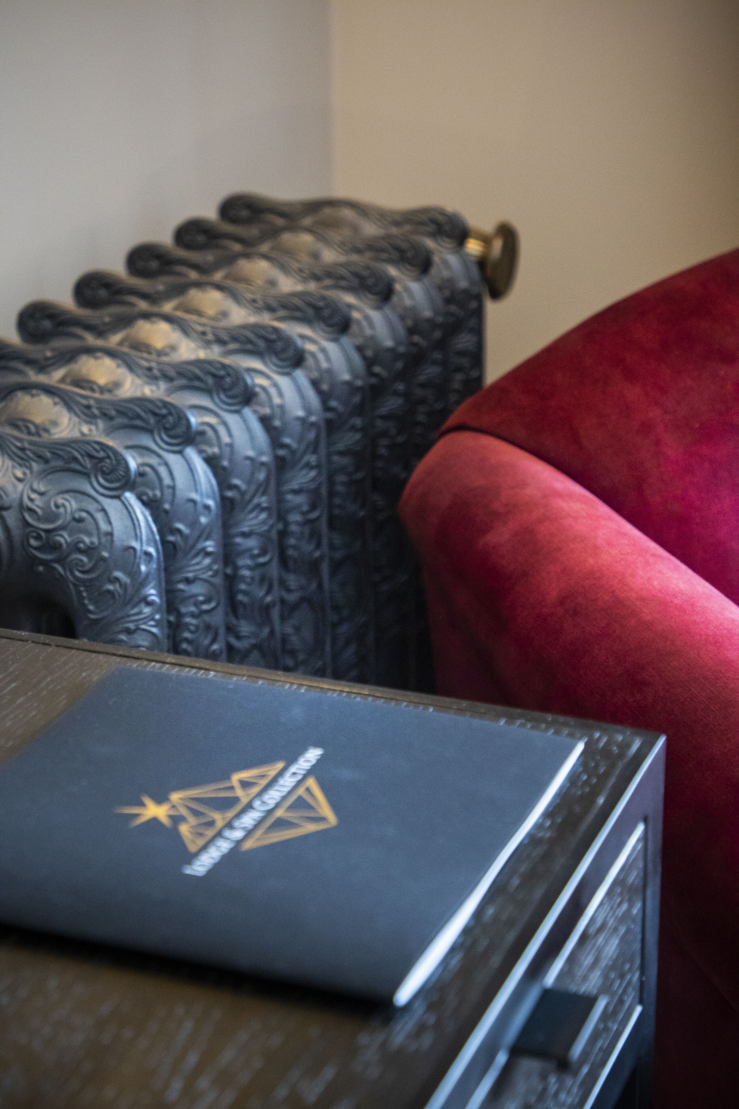 A close-up of a book with a star and geometric design on the cover, placed on a wooden surface.
