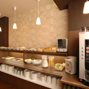 A buffet area with various food items, a microwave, and a coffee maker. - Ab Hotel Gifu (Gifu)