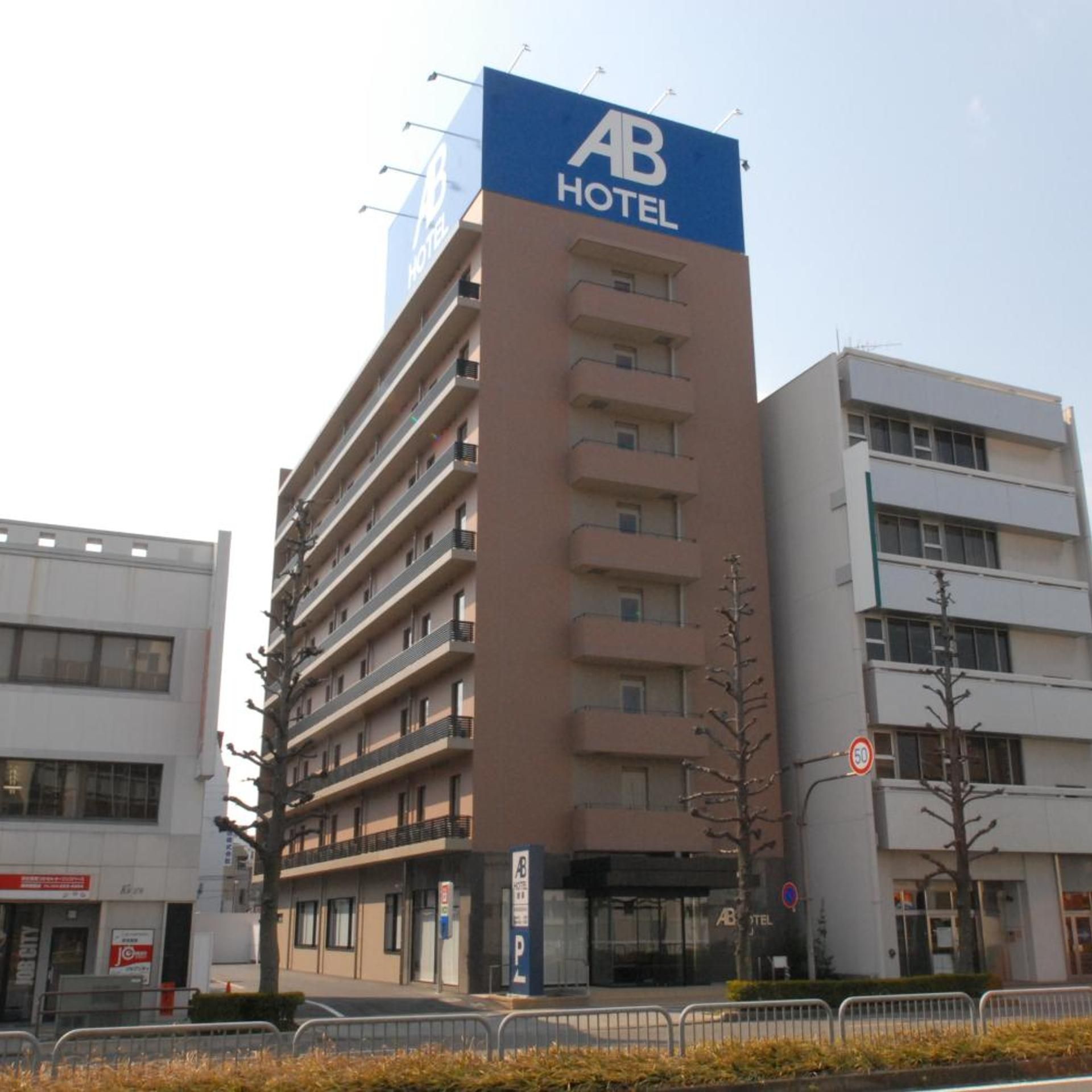 A multi-story hotel building with a prominent 'AB HOTEL' sign on the facade.