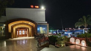 A hotel entrance with a large arched doorway, a reception desk, and a sign indicating a gym. - Luxurious and Panoramic Nile view. (Cairo)
