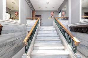 A marble staircase with green railings and wooden handrails, leading to a door at the top. - Waterfront Penthouse Apt. with a Stunning View (İstanbul)