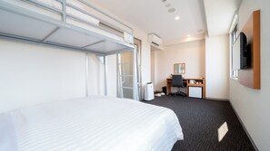 A hotel room with a bunk bed, a desk with a chair, a small refrigerator, and a flat-screen TV mounted on the wall. - Super Hotel Kumamoto Yamaga (Yamaga)
