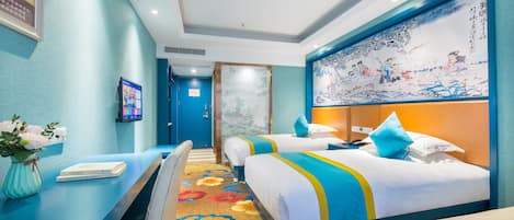 A hotel room with two beds, a desk, and a large decorative wall.