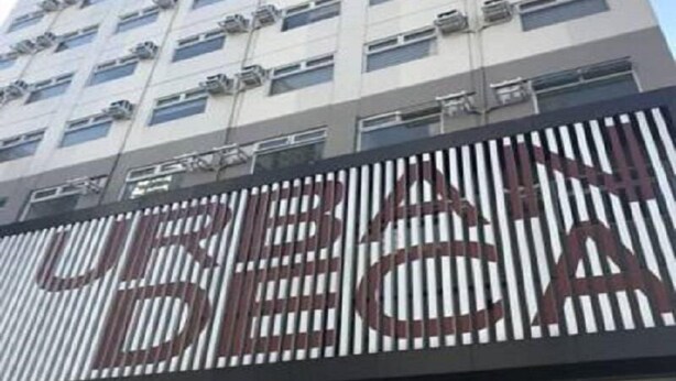 A high-rise building with a large sign that reads "CITIZEN."
