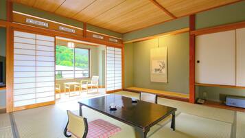 A traditional Japanese room with tatami flooring, a low table, and shoji screens.