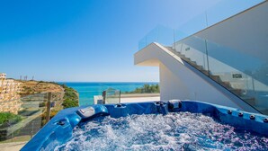 A hot tub with a clear view of the sea, a modern staircase, and a glass railing. - Villa Centeanes Luxury villa,enviable position stunning sea views! (Carvoeiro)