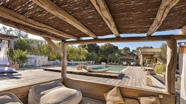 A wooden deck with a pool, lounge chairs, and a pergola. - Sheepfold, 4 bedrooms, 10 people, heated pool (Bonifacio)