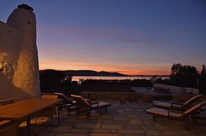 Relax on the outdoor terrace with a view of the water.