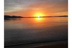 Experience serene lake views with a peaceful sunset.