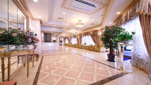 A spacious lobby with a reception desk, seating area, and decorative plants. - Hotel Capital In Yamagata (Yamagata)