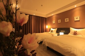 A hotel room with two beds, a large window with curtains, and a wall-mounted clock.