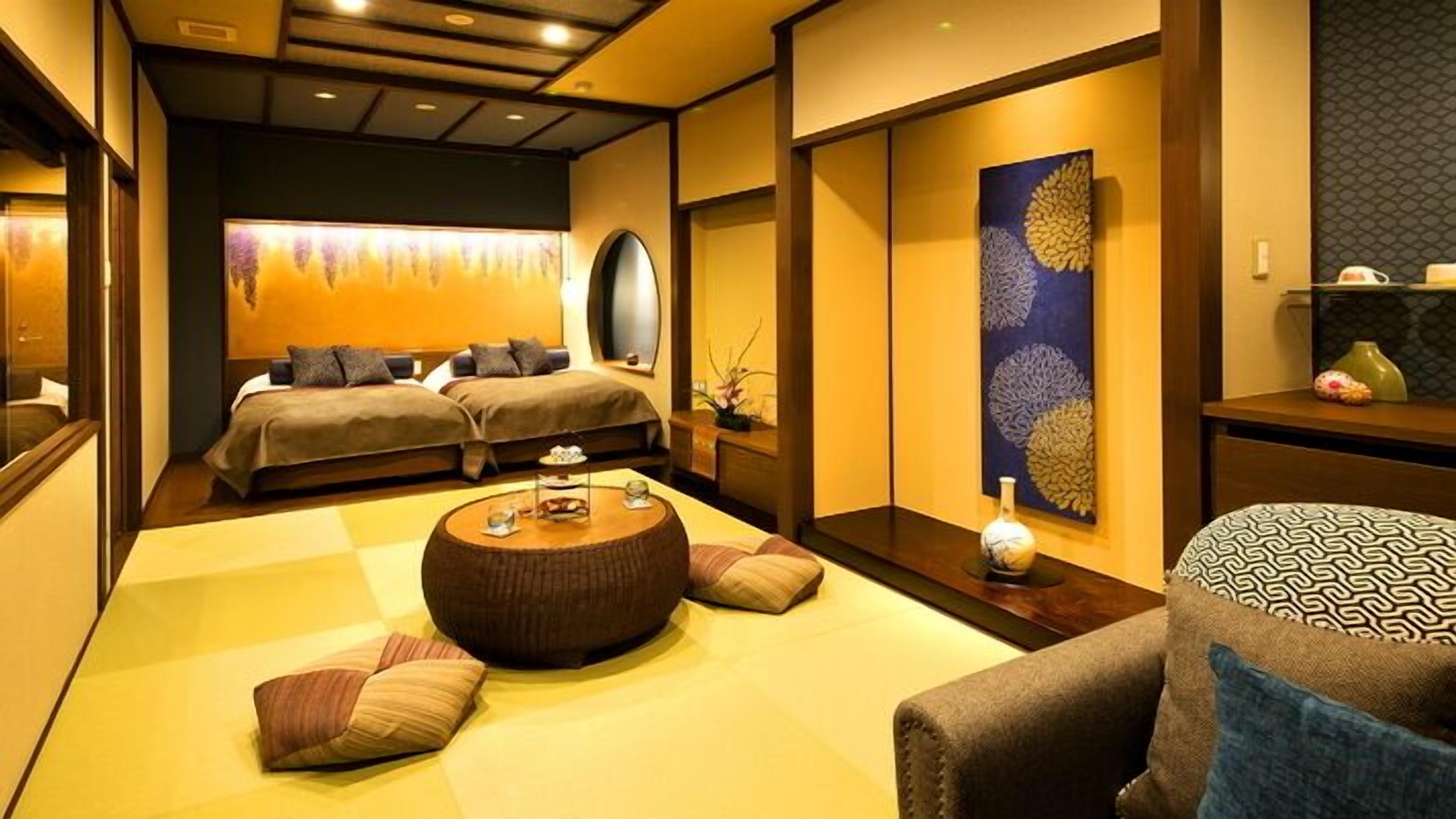 A traditional Japanese-style room with tatami flooring, a low table, and a sofa.