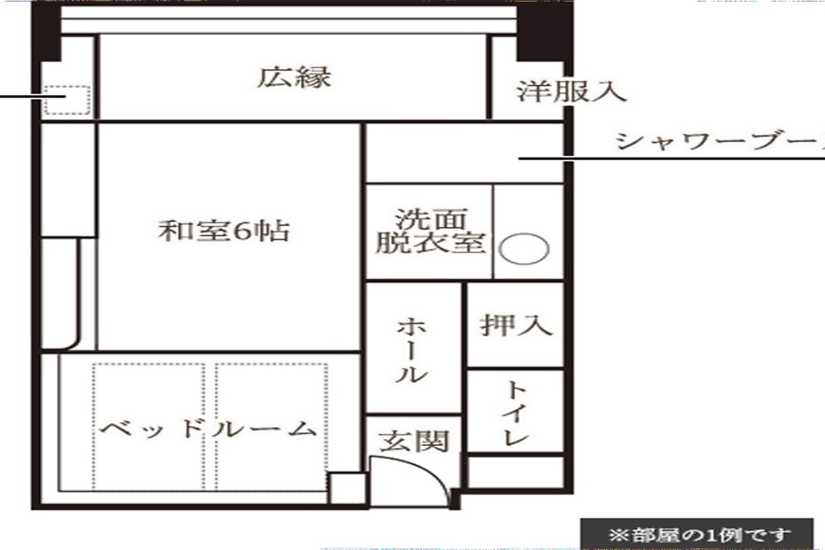A hotel floor plan with a large central room, a bathroom, a shower room, a bed room, and a sitting area.