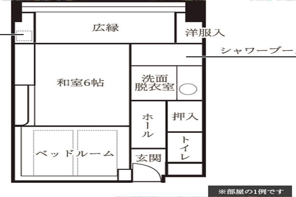 A hotel floor plan with a large central room, a bathroom, a shower room, a bed room, and a sitting area.