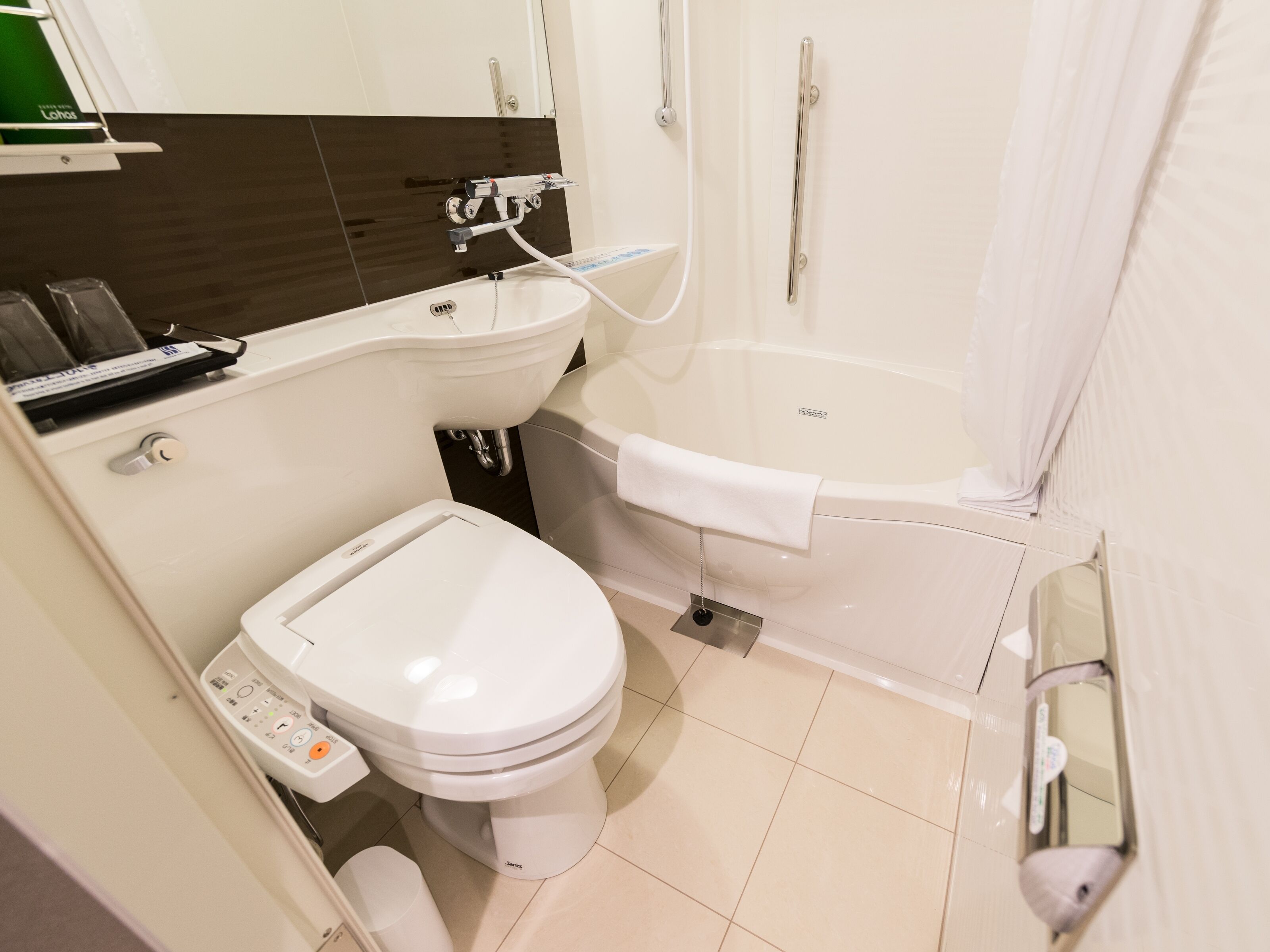 A modern bathroom with a toilet, sink, and bathtub.