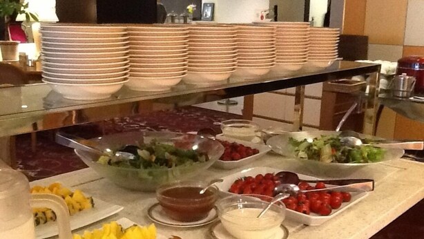 A buffet with various food items and serving utensils.
