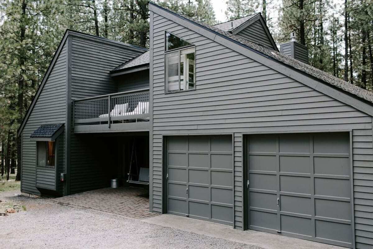 A modern two-story house with a garage and a balcony.