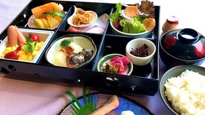 A bento box with various food items including fish, vegetables, and rice. - Hotel Fukushima Green Palace (Fukushima)