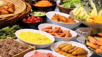 A variety of food items including noodles, scrambled eggs, and fried snacks.