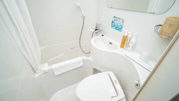 A modern bathroom with a toilet, sink, and shower.