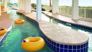 A swimming pool with a curved edge, clear water, and yellow floating rings. - Spacious Oceanfront Resort with Onsite Restaurant, 5 Pools, 2 indoor Pools and Beach Access (Myrtle Beach)