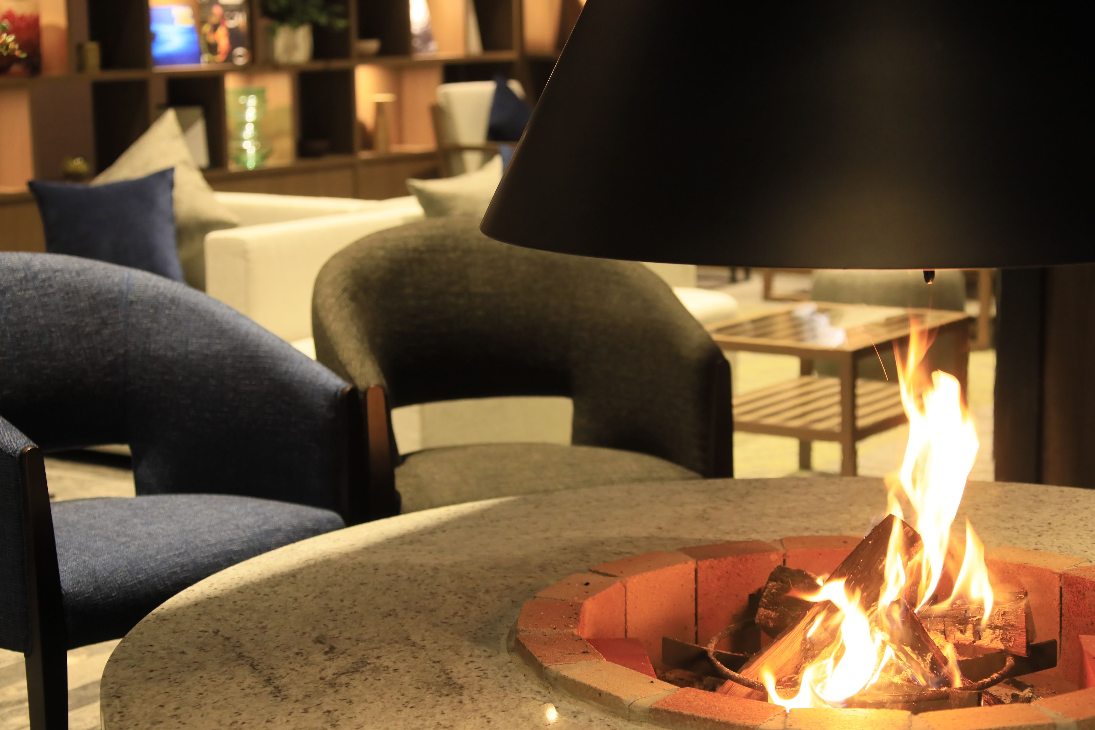 Un rincón acogedor con zona de estar, una chimenea y mobiliario moderno.
