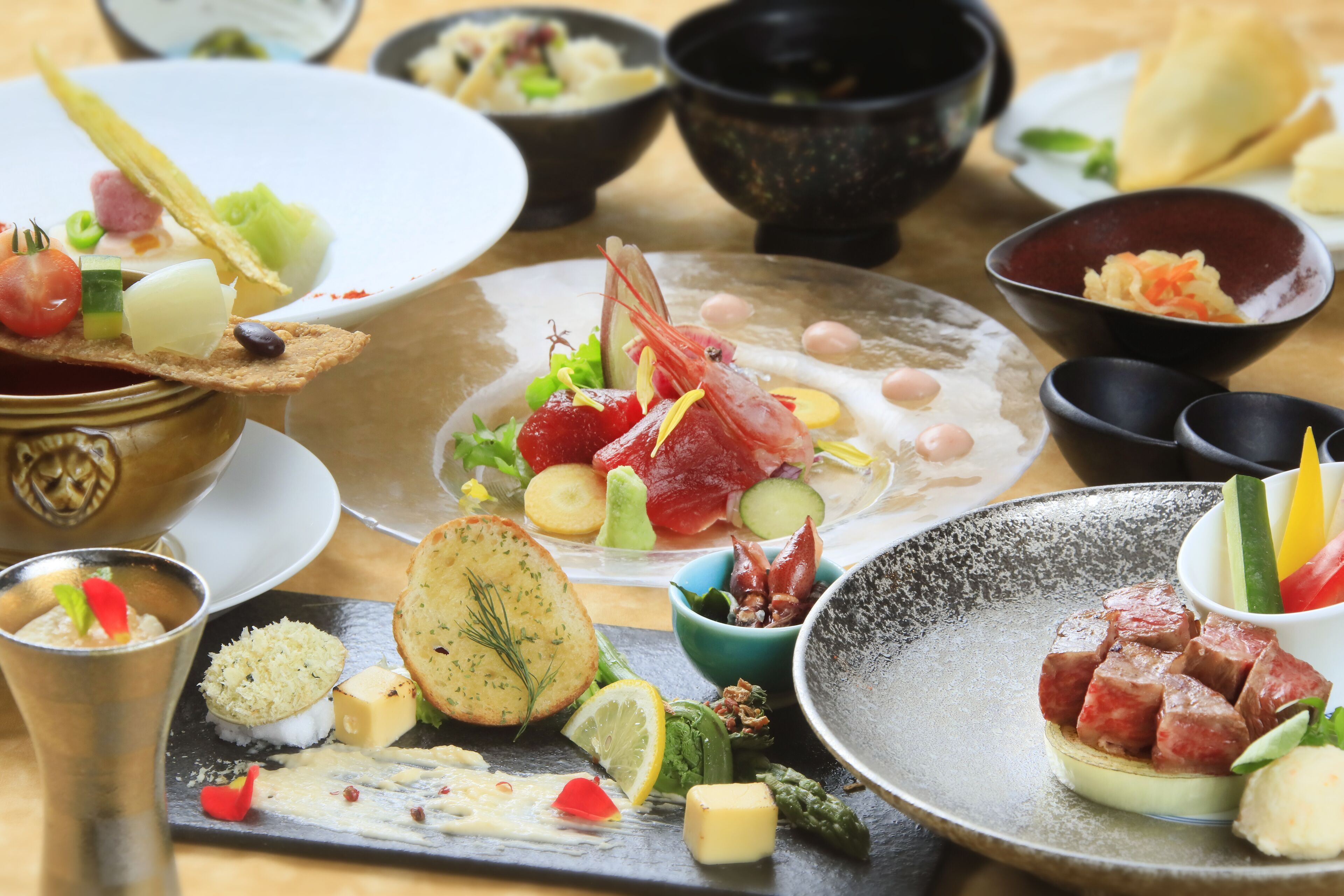 A variety of dishes on a table, including seafood, cheese, and vegetables.