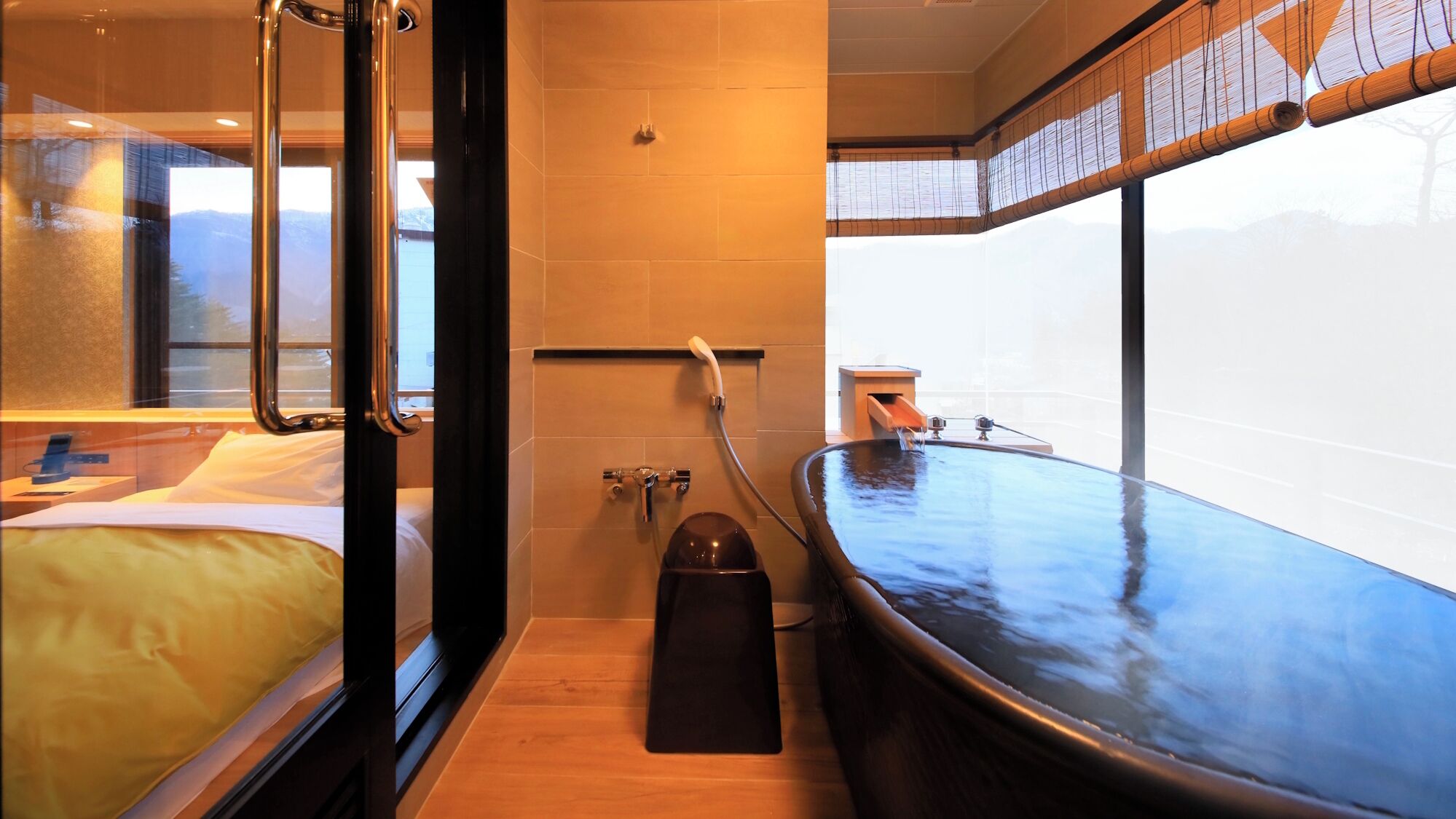 A modern bathroom with a bathtub, a shower, and a toilet.