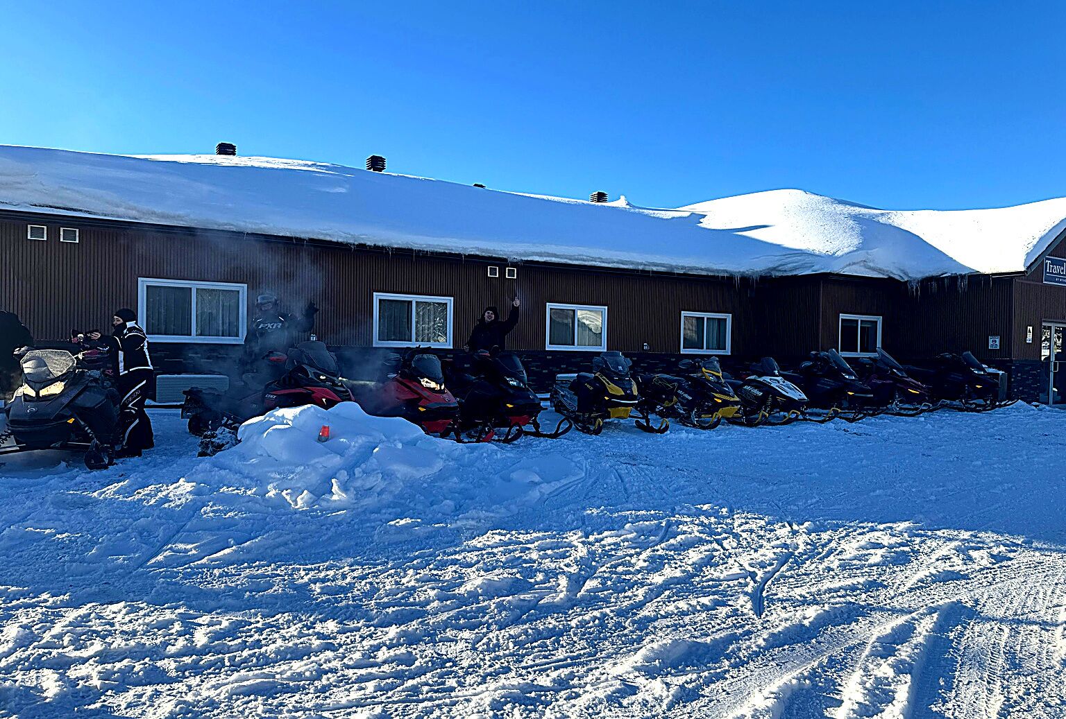 A building with multiple windows and a snow-covered roof.