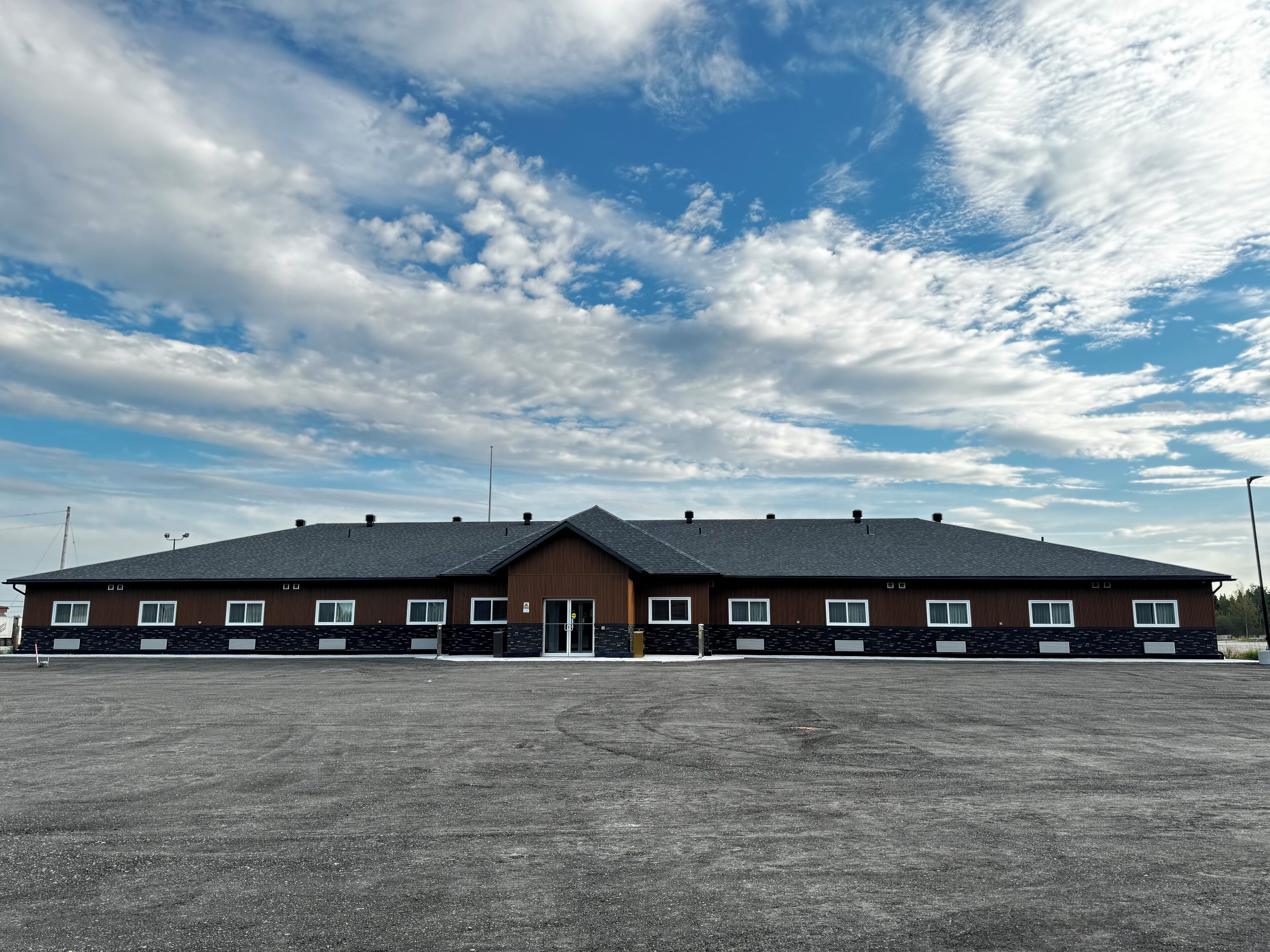 A large, single-story building with a flat roof and multiple windows.